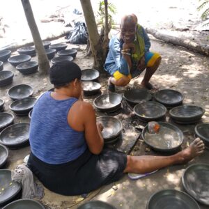 Individuals working on a pottery project in Gamakope Village in Ghana