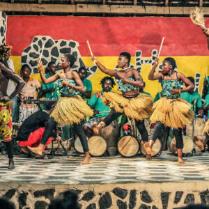 Performers in Ghana performing anAfrican dance and playing drums